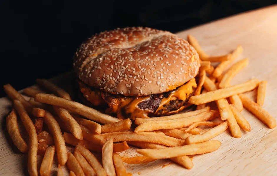 Cheeseburger and french fries on a tray, illustrative photo of typical fast food menu items